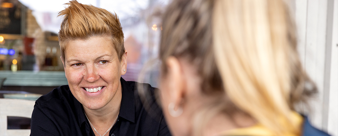 Två personer på en utbildning pratar med varandra